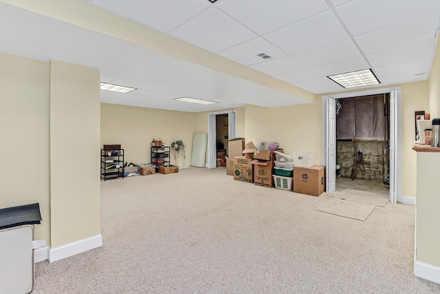 basement featuring carpet flooring and a drop ceiling