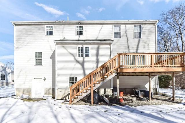 snow covered property featuring a deck