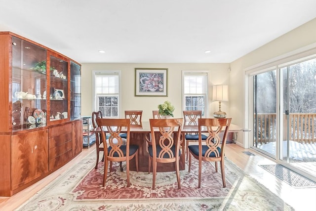 dining area with a wealth of natural light and light hardwood / wood-style floors