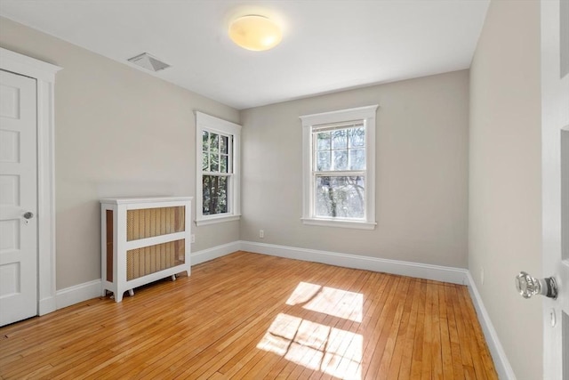 spare room with light wood-style flooring and baseboards