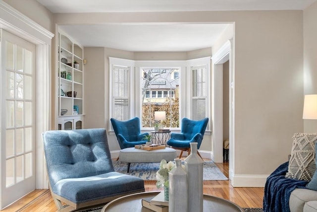 sitting room featuring baseboards and wood finished floors