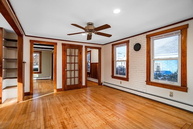 unfurnished room with a baseboard radiator, ornamental molding, and light hardwood / wood-style flooring