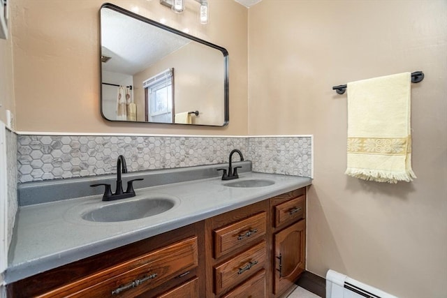 bathroom featuring a baseboard radiator, vanity, and decorative backsplash