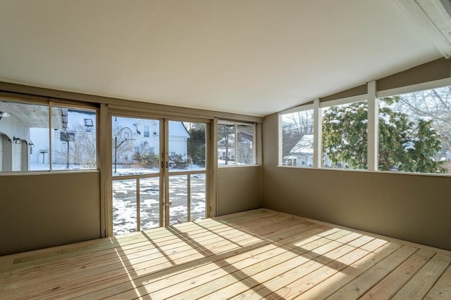 unfurnished sunroom featuring lofted ceiling