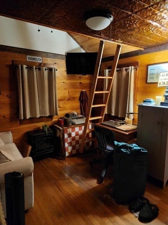 office featuring an ornate ceiling, wooden walls, and hardwood / wood-style flooring