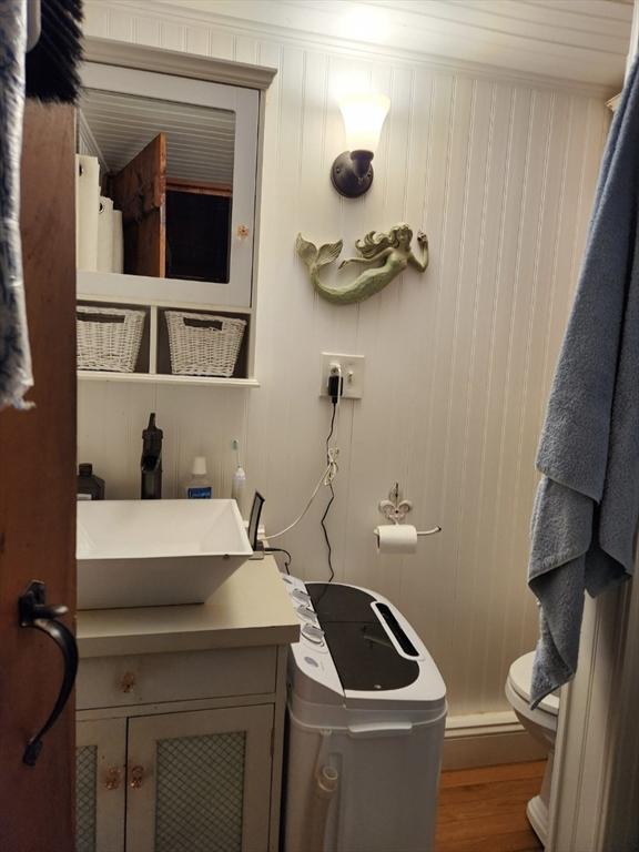 638 Rte 28 Unit 16, Yarmouth, MA 02673 - bathroom featuring vanity, toilet, wood finished floors, and ornamental molding
