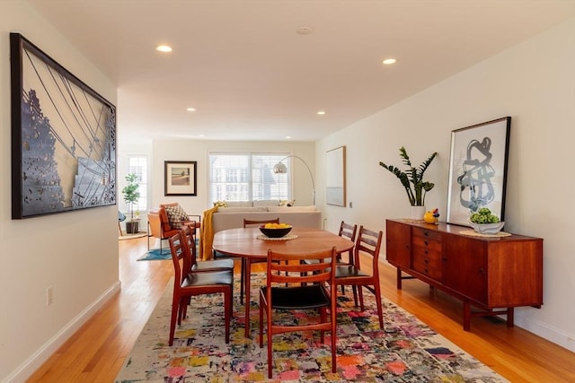 dining area featuring light wood-style floors, baseboards, and recessed lighting