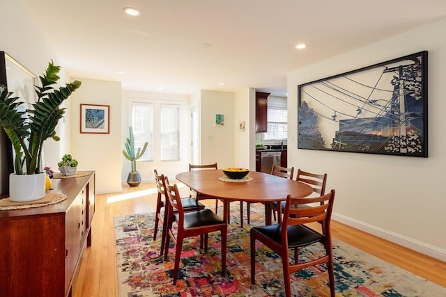 dining room with recessed lighting, light wood-style flooring, and baseboards