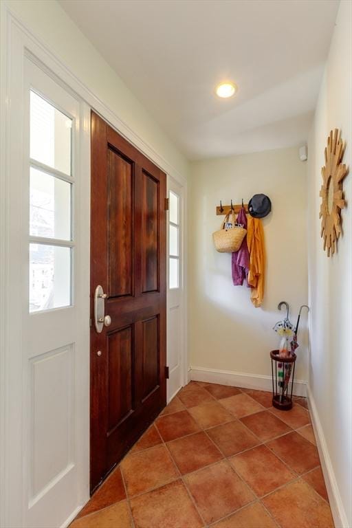 doorway with light tile patterned floors, recessed lighting, and baseboards