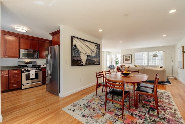 dining space featuring light wood finished floors, baseboards, and recessed lighting