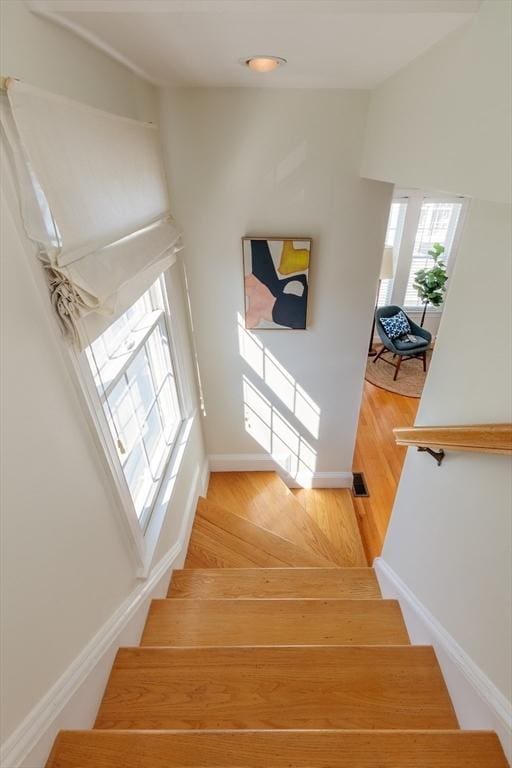 stairs featuring baseboards and wood finished floors