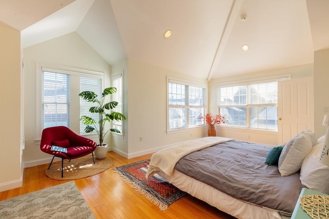 bedroom featuring baseboards, vaulted ceiling, and wood finished floors