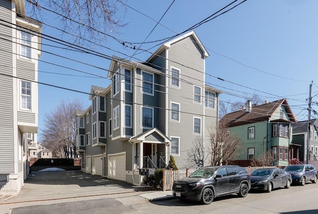 view of building exterior with a residential view and an attached garage