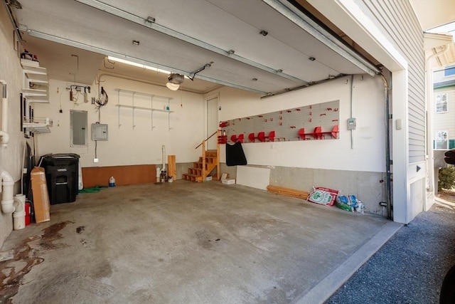 garage with a garage door opener and electric panel