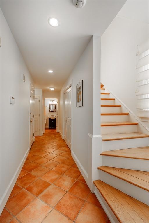 hall with stairway, recessed lighting, light tile patterned flooring, and baseboards