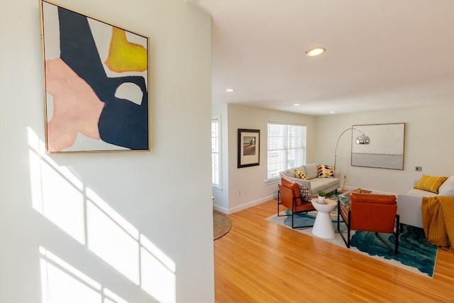 living room featuring baseboards, wood finished floors, and recessed lighting