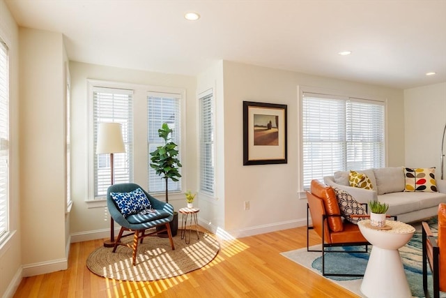 living area with light wood-style flooring, a wealth of natural light, and recessed lighting