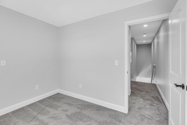 empty room featuring carpet floors, baseboards, and recessed lighting