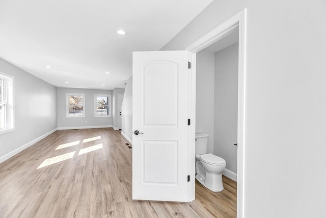 bathroom with recessed lighting, toilet, baseboards, and wood finished floors