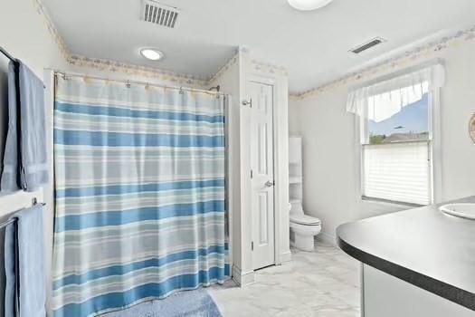 65 Tussock Brook Rd Unit 65, Duxbury, MA 02332 - full bath featuring vanity, toilet, marble finish flooring, and a shower with curtain