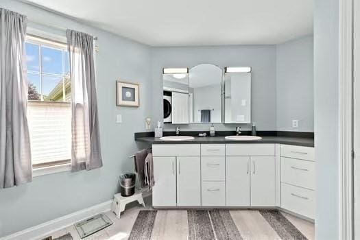 65 Tussock Brook Rd Unit 65, Duxbury, MA 02332 - full bathroom with double vanity, plenty of natural light, wood finished floors, and baseboards