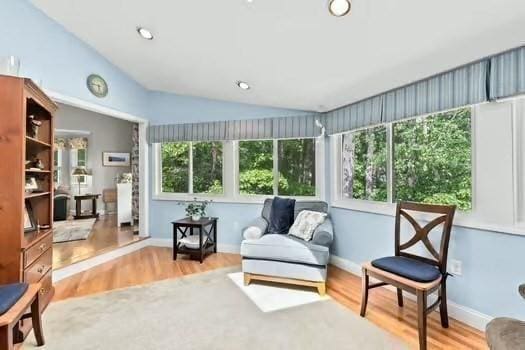 65 Tussock Brook Rd Unit 65, Duxbury, MA 02332 - sitting room with vaulted ceiling, wood finished floors, and baseboards