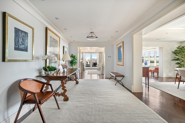 hall featuring parquet flooring, ornamental molding, and a healthy amount of sunlight