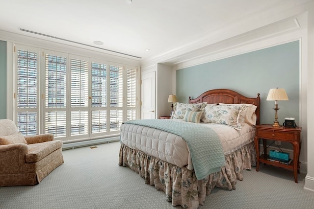 carpeted bedroom featuring crown molding