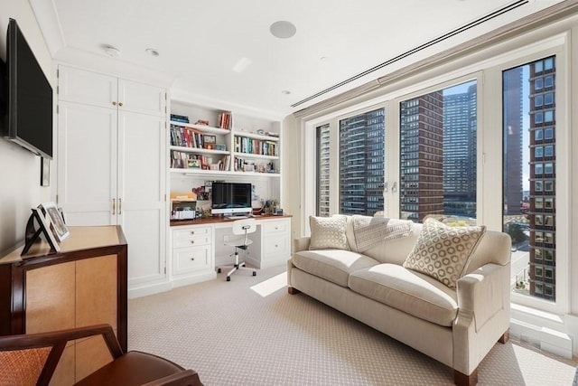 living room featuring light carpet and built in study area