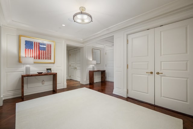 unfurnished bedroom featuring dark parquet floors, crown molding, and a closet