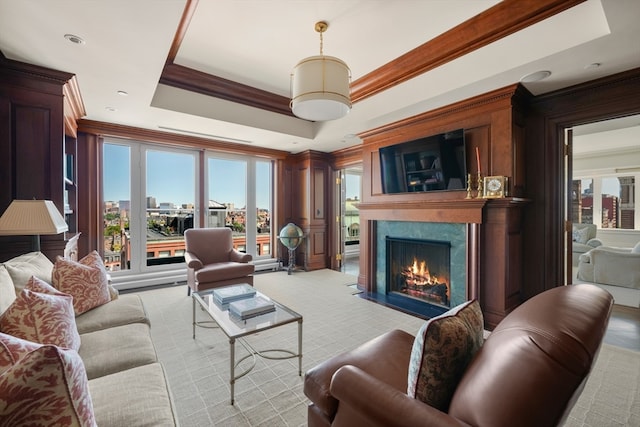 living room with a tray ceiling and crown molding