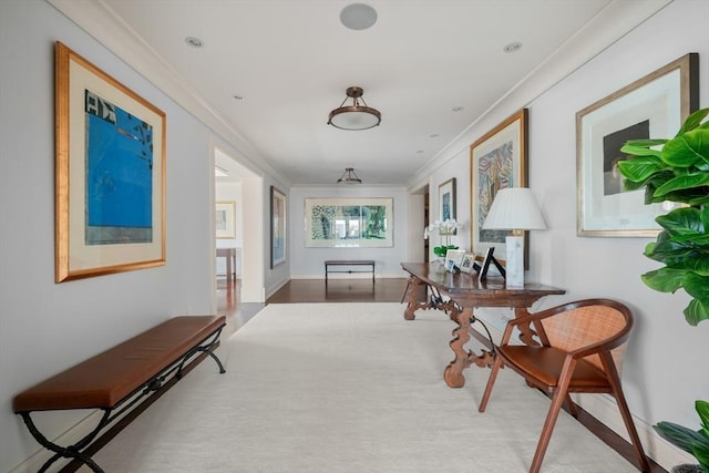 hallway featuring wood finished floors and ornamental molding