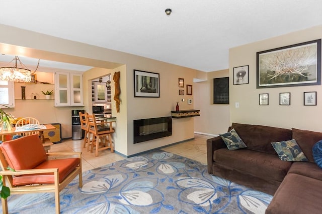 living room featuring light tile patterned floors and a notable chandelier