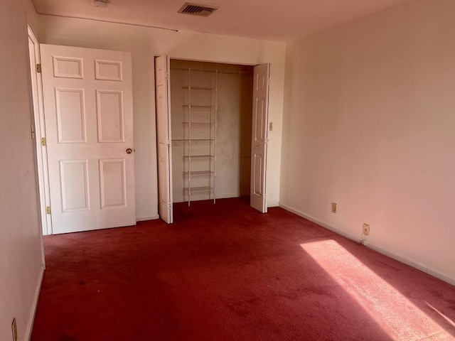24 Corey St Unit 305, Everett, MA 02149 - unfurnished bedroom featuring dark carpet, a closet, and baseboards
