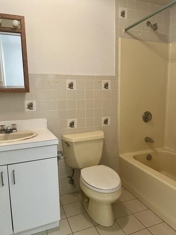 24 Corey St Unit 305, Everett, MA 02149 - full bathroom featuring vanity, shower / tub combination, tile patterned flooring, toilet, and tile walls