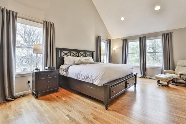 bedroom featuring light wood-style floors, recessed lighting, baseboards, and high vaulted ceiling