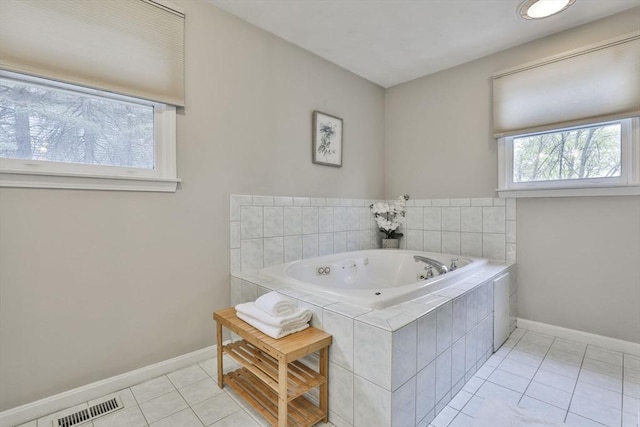 full bath featuring baseboards, tile patterned flooring, a tub with jets, and visible vents