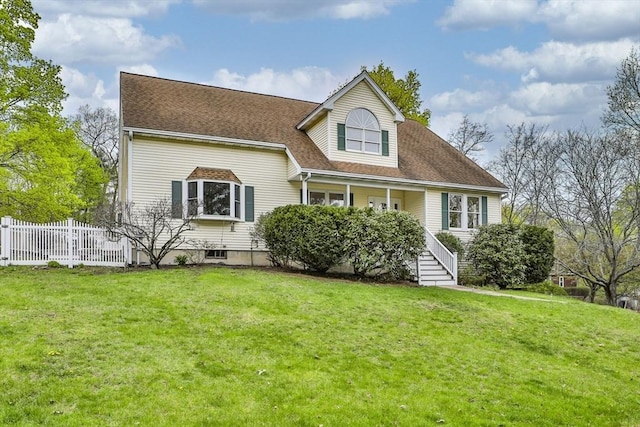 back of property with fence, covered porch, roof with shingles, a lawn, and stairway