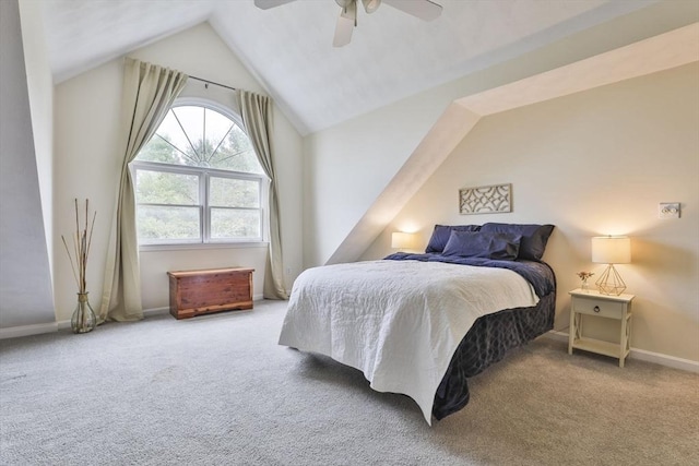 carpeted bedroom featuring a ceiling fan, baseboards, and vaulted ceiling
