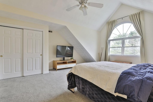bedroom with carpet flooring, ceiling fan, vaulted ceiling, visible vents, and a closet