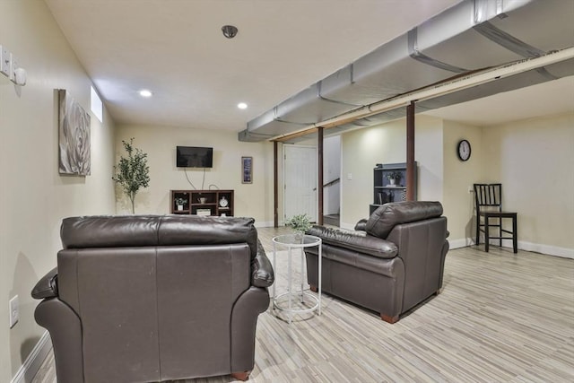 living area featuring baseboards, recessed lighting, and light wood-type flooring