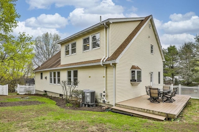 back of property with roof with shingles, a deck, central AC, fence, and outdoor dining space