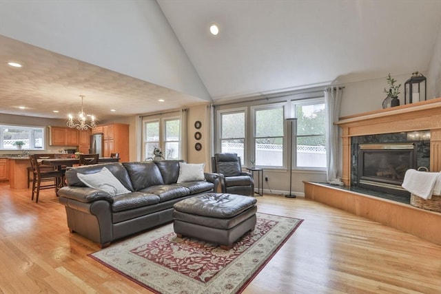 living room featuring recessed lighting, light wood finished floors, and a chandelier