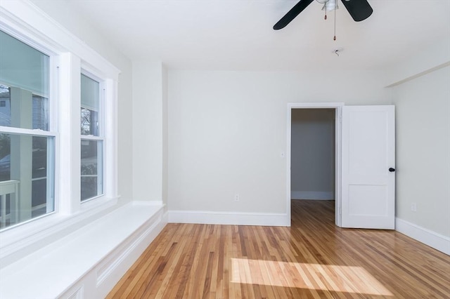 empty room featuring ceiling fan and light wood-type flooring