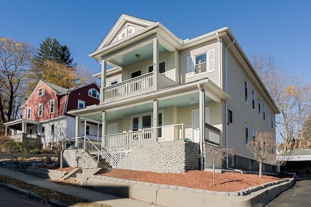 view of front of house featuring covered porch and a balcony