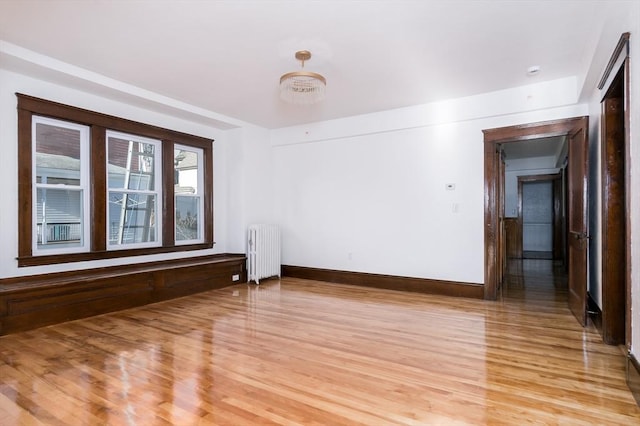 empty room featuring radiator and light hardwood / wood-style floors