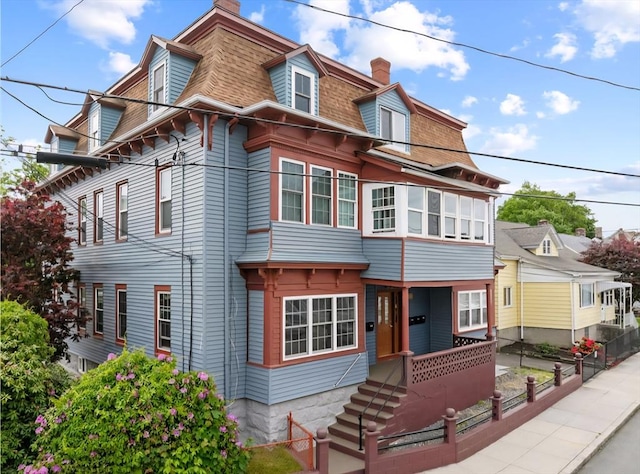 186 John St, Fall River, MA 02721 - victorian home featuring a chimney, roof with shingles, and mansard roof
