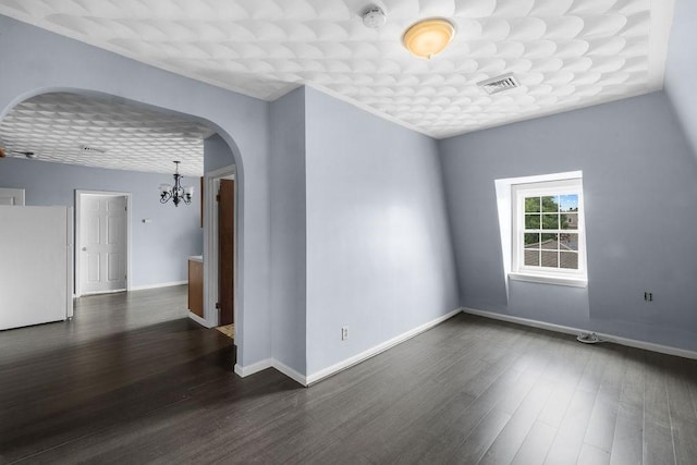 186 John St, Fall River, MA 02721 - unfurnished room with a chandelier, arched walkways, a smoke detector, dark wood-type flooring, and baseboards