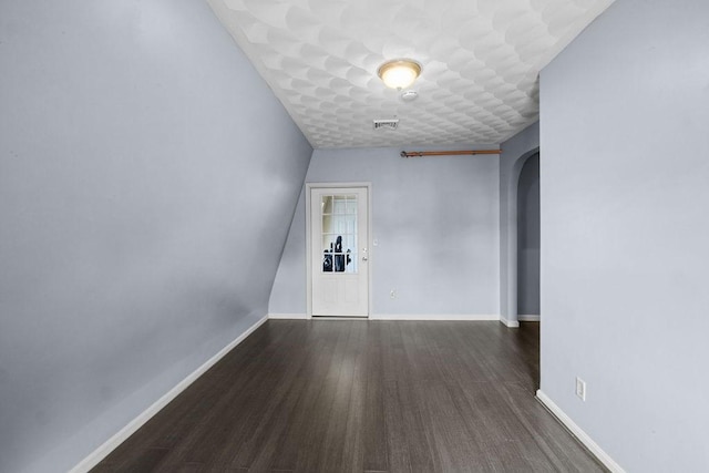 186 John St, Fall River, MA 02721 - unfurnished room with arched walkways, wood finished floors, and baseboards