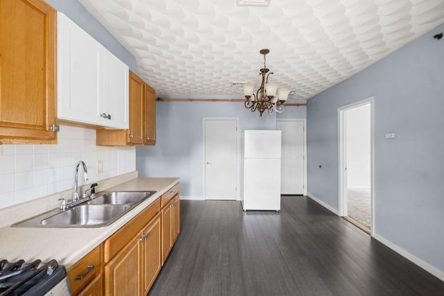 186 John St, Fall River, MA 02721 - kitchen with freestanding refrigerator, a sink, range, baseboards, and light countertops